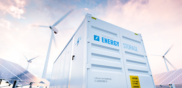 A batter energy storage system with wind turbines in the background